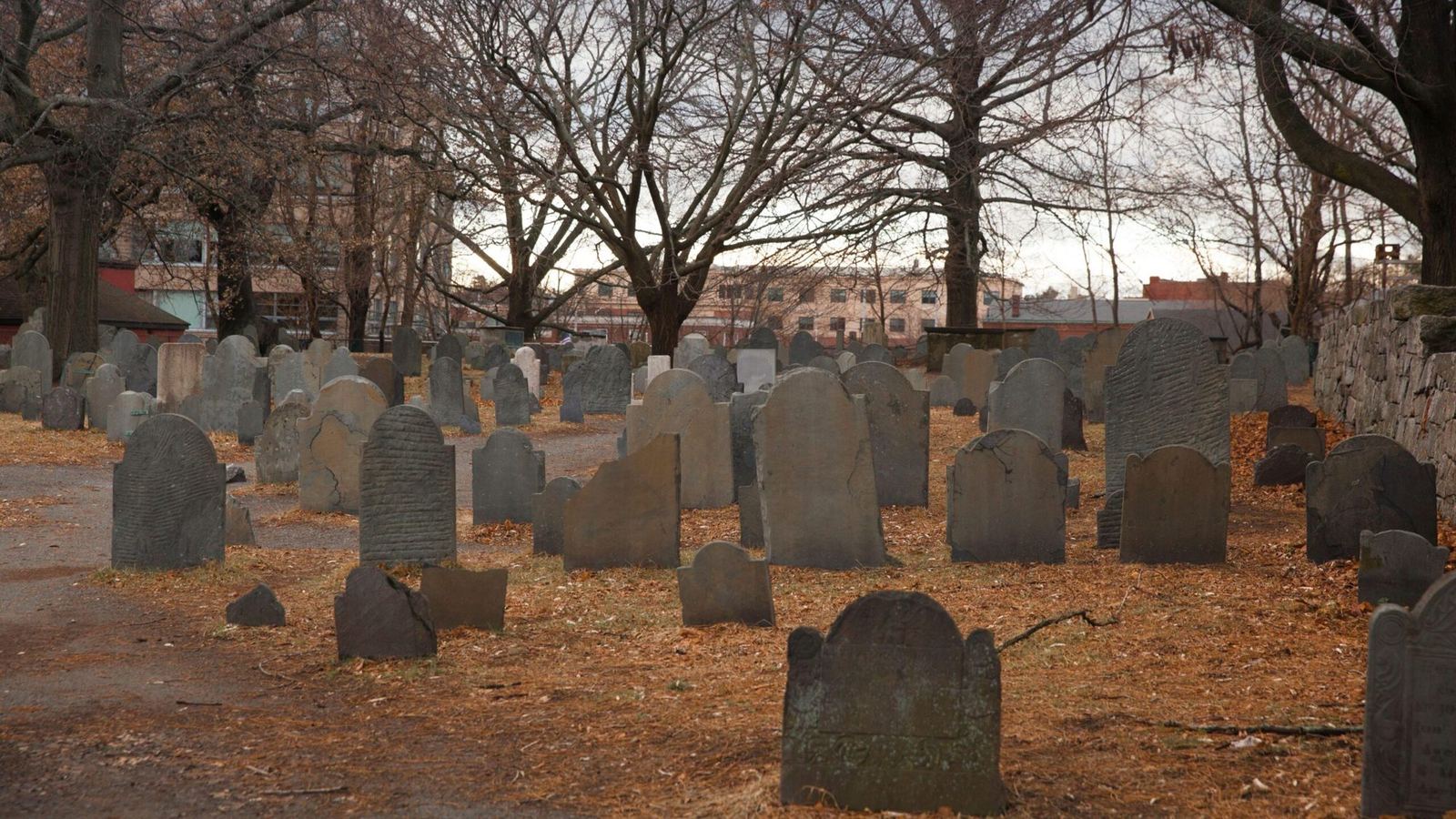Weathered slate headstones in the Old Burying Point on Charter Street